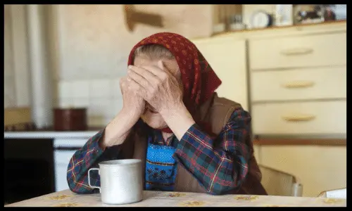 Elderly Person Covering Face