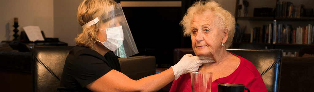 Image of masked healthcare person testing for Dysphagia in the Elderly
