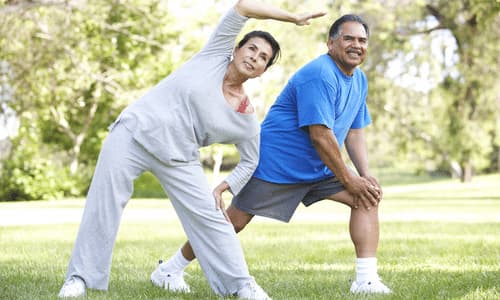 Older Adults Stretching in the Park.